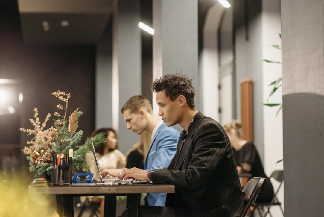 Professional developers at Changeable working on laptops in a modern, architecturally designed office in New Plymouth. The setting is professional and focused, representing high-level AI implementation and technical deep work in Taranaki, NZ.